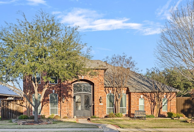 view of front of property featuring french doors and a front yard