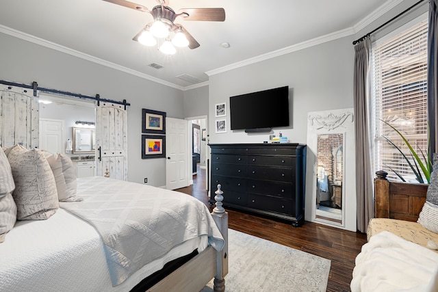 bedroom featuring a barn door, ornamental molding, ceiling fan, connected bathroom, and dark hardwood / wood-style floors