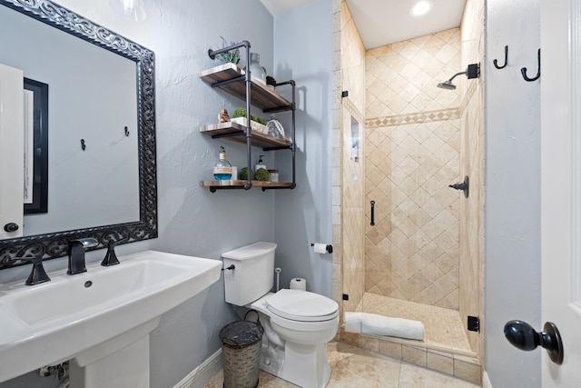 bathroom featuring sink, toilet, walk in shower, and tile patterned flooring