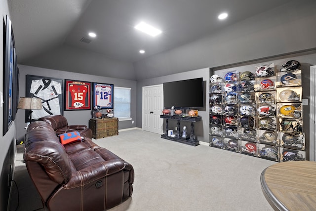 carpeted home theater room featuring vaulted ceiling