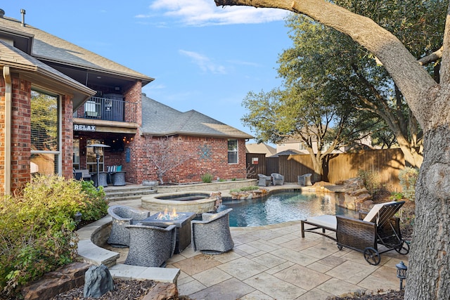 view of swimming pool with an in ground hot tub and a patio area