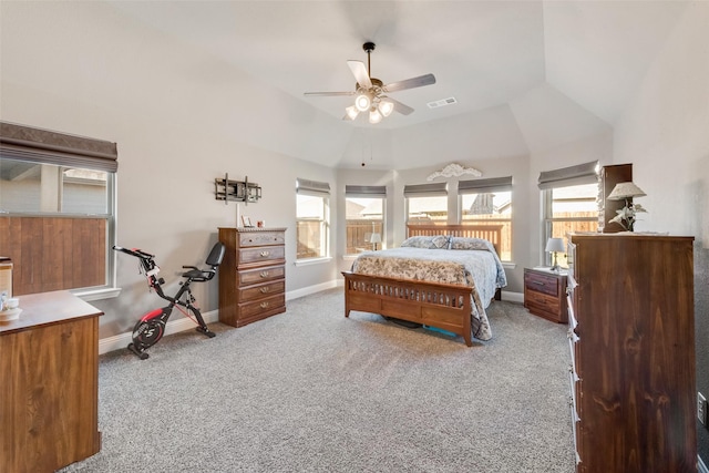 bedroom with light carpet, ceiling fan, lofted ceiling, and multiple windows