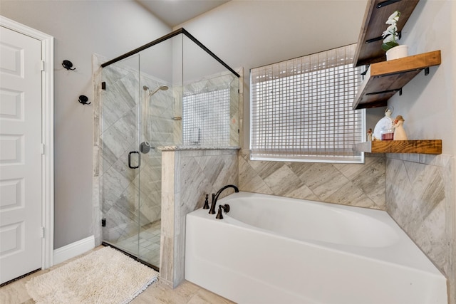 bathroom featuring shower with separate bathtub