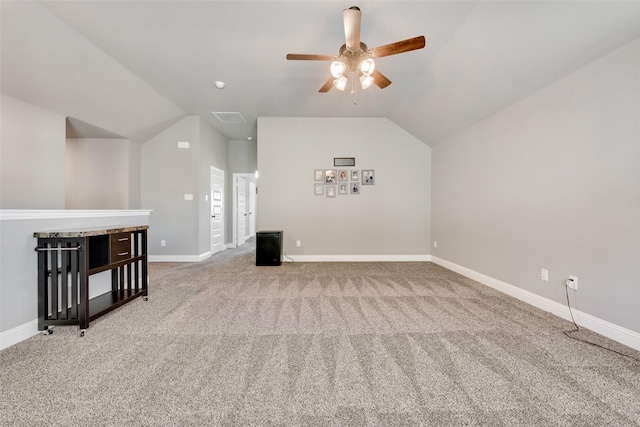 additional living space with ceiling fan, lofted ceiling, and carpet flooring