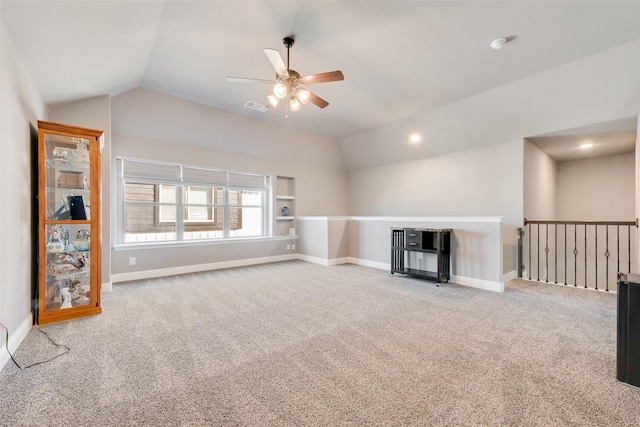 unfurnished living room with lofted ceiling, ceiling fan, and carpet floors