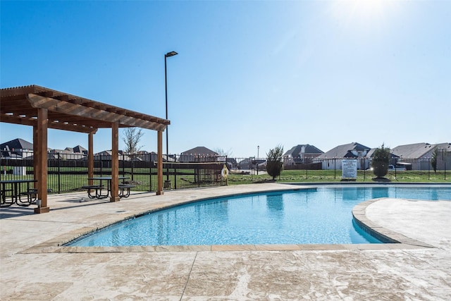 view of swimming pool with a patio and a pergola