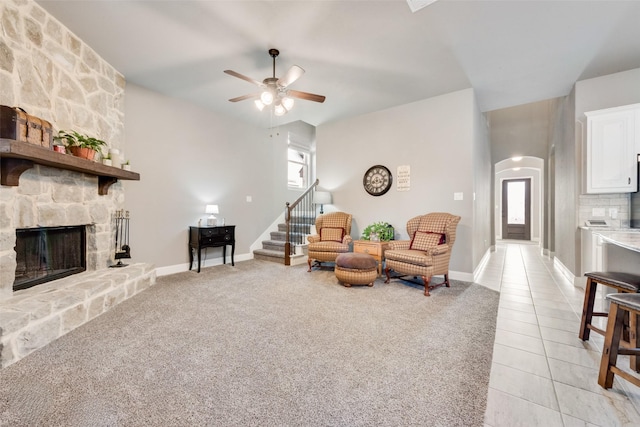 living room with ceiling fan, light tile patterned floors, a fireplace, and plenty of natural light