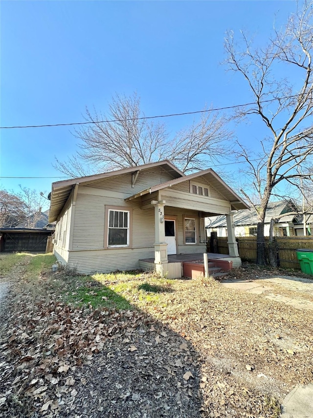 bungalow-style home featuring fence and covered porch