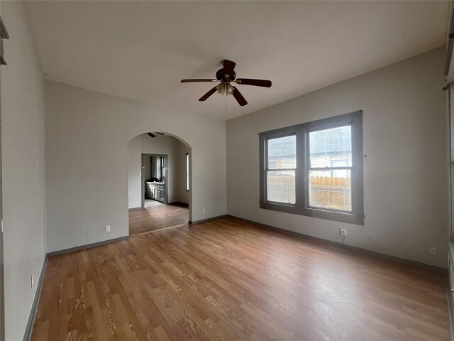 empty room with wood-type flooring and ceiling fan