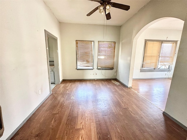 empty room with hardwood / wood-style floors and ceiling fan