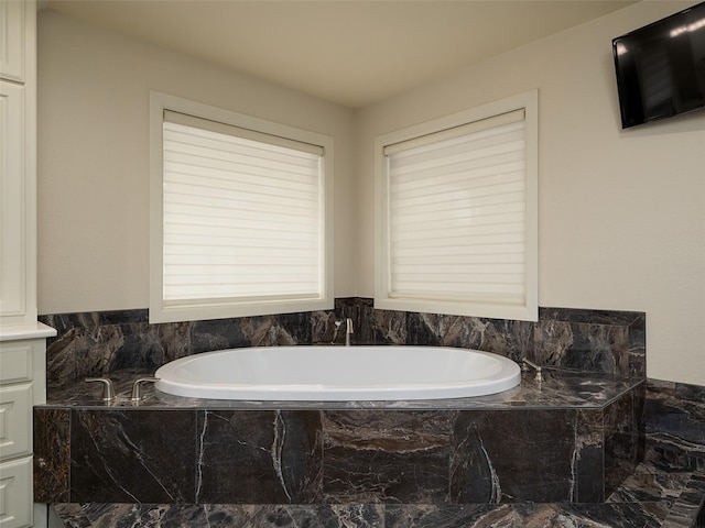 bathroom with tiled tub