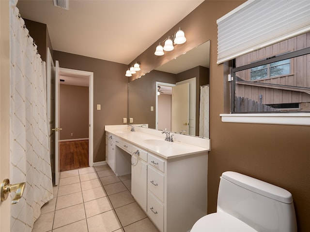 bathroom with ceiling fan, tile patterned flooring, vanity, and toilet