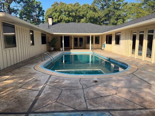 view of pool featuring french doors and a patio area