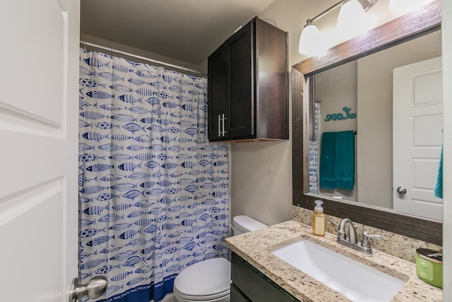 bathroom featuring toilet and vanity