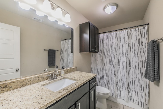 bathroom featuring toilet, tile patterned floors, and vanity