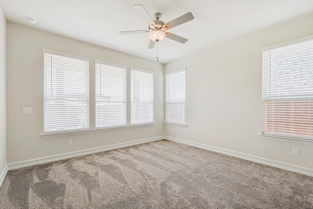 spare room featuring ceiling fan and carpet floors