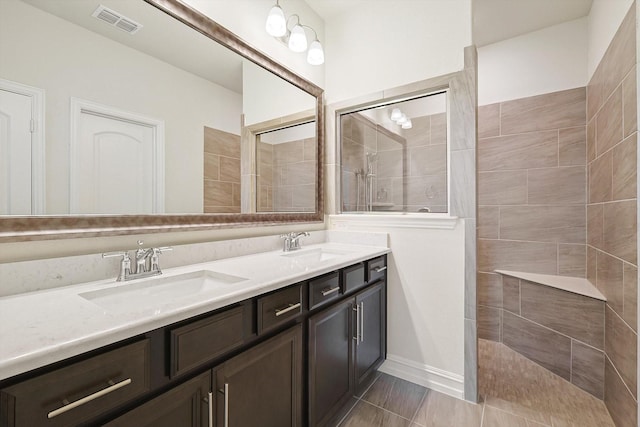 bathroom featuring vanity and tiled shower