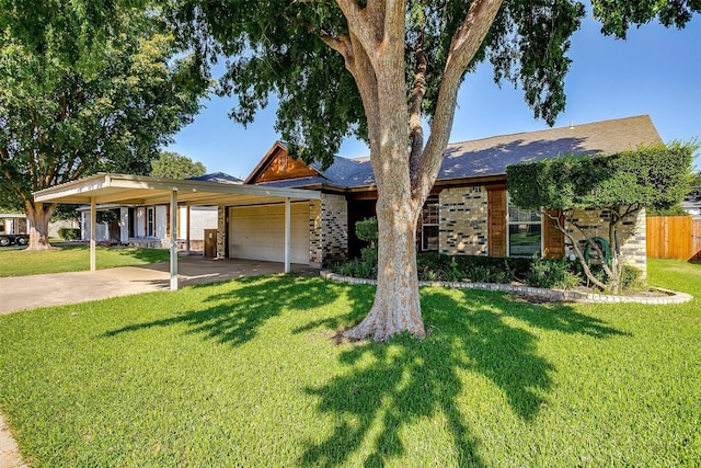 view of front of home featuring a front lawn, a carport, and a garage