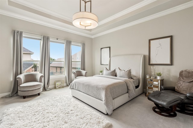 bedroom with a tray ceiling, ornamental molding, and carpet