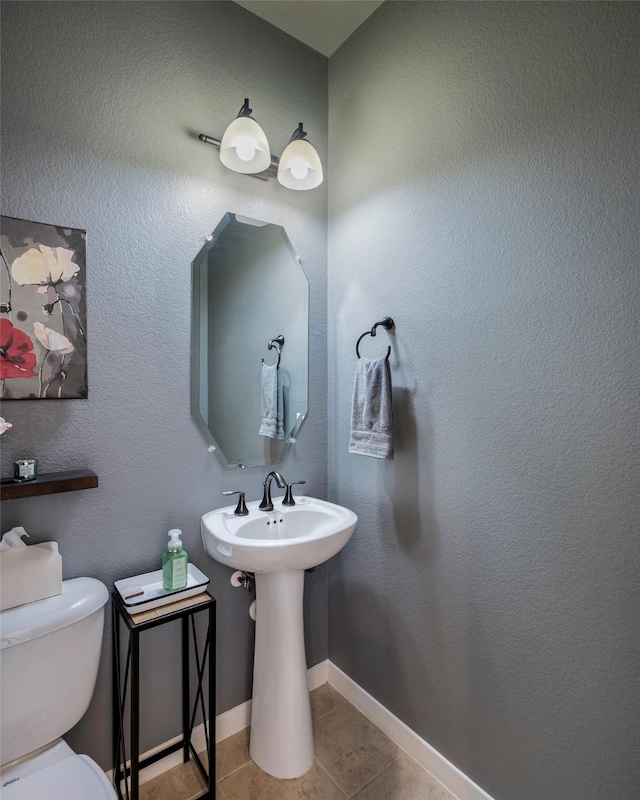 bathroom featuring tile patterned floors and toilet