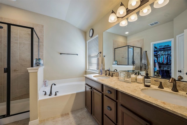 bathroom featuring lofted ceiling, vanity, tile patterned floors, and independent shower and bath