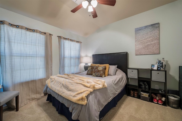 carpeted bedroom featuring vaulted ceiling and ceiling fan