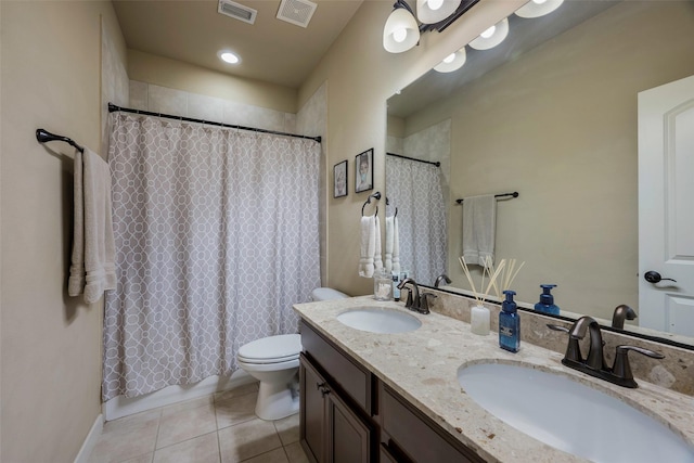 bathroom with tile patterned floors, vanity, and toilet