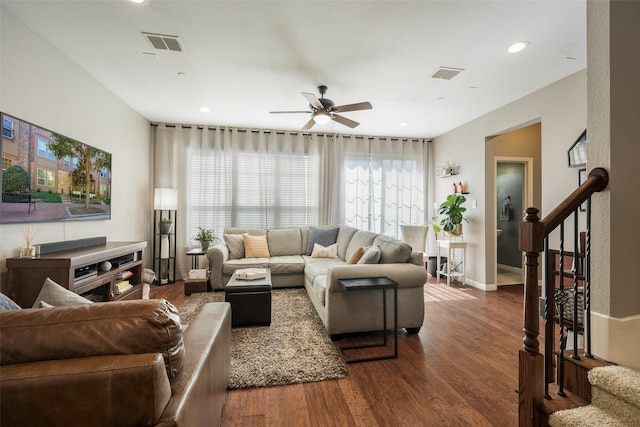 living room featuring ceiling fan and dark wood-type flooring