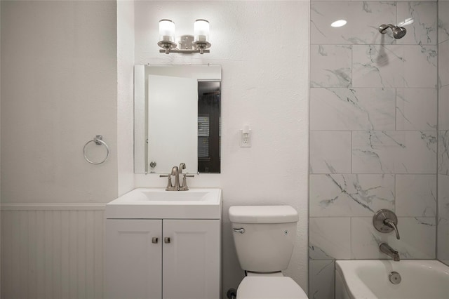 full bathroom featuring vanity, toilet, and tiled shower / bath