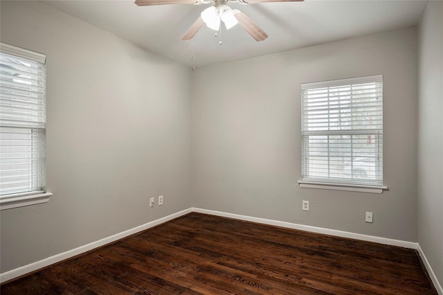 spare room featuring ceiling fan and dark wood-type flooring