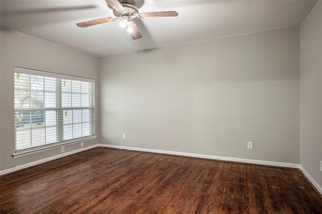 empty room featuring ceiling fan and dark wood-type flooring