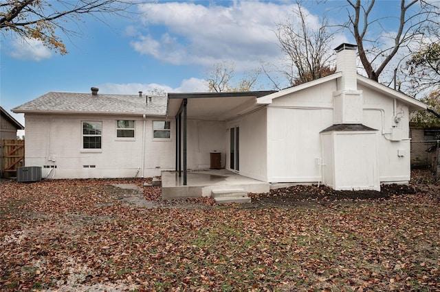 rear view of house featuring central air condition unit