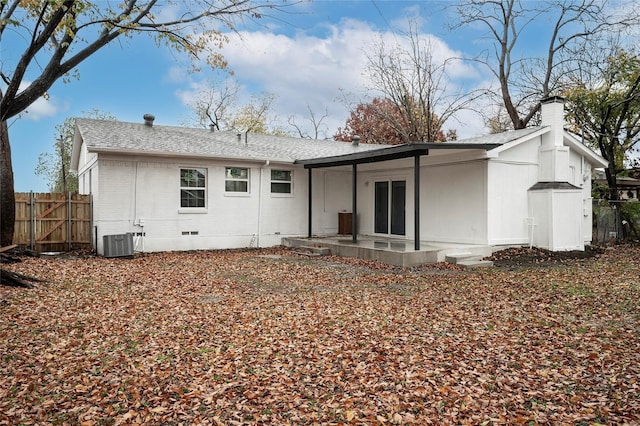 back of house with central air condition unit