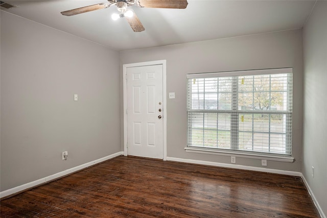 empty room with dark hardwood / wood-style floors and ceiling fan