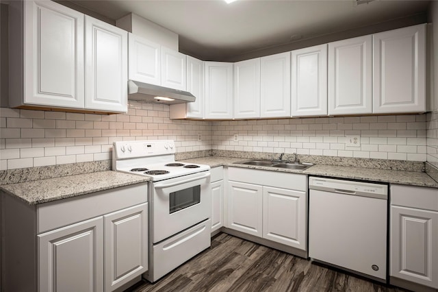 kitchen featuring backsplash, white appliances, sink, white cabinets, and dark hardwood / wood-style floors