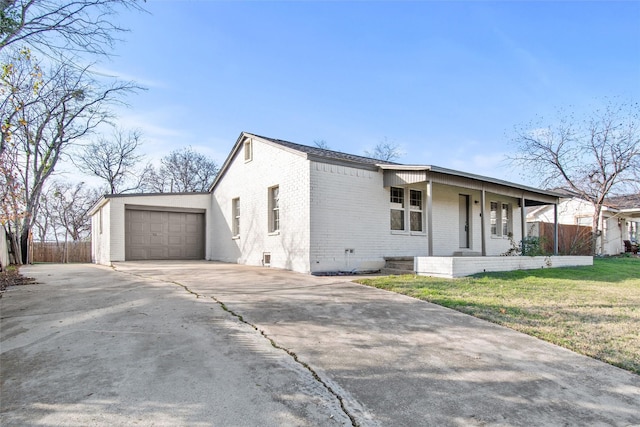 view of front of house with a garage, covered porch, and a front yard