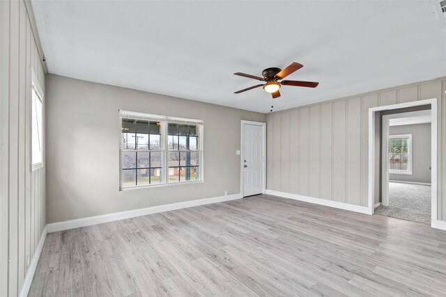 empty room with light wood-type flooring and ceiling fan