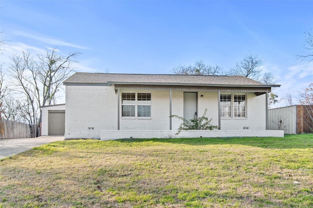 ranch-style home featuring a porch, a garage, an outbuilding, and a front lawn