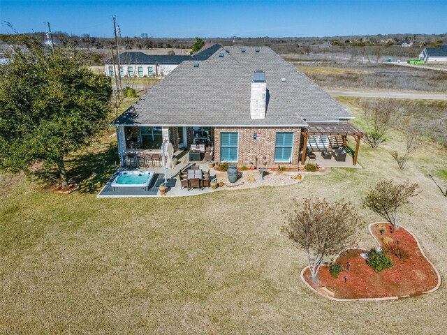 back of house featuring a pergola, a patio area, and a lawn