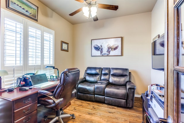 home office with ceiling fan and light hardwood / wood-style floors