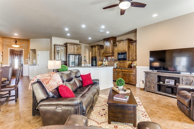 tiled living room featuring ceiling fan and sink