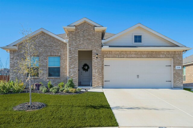 view of front of property with a garage and a front lawn