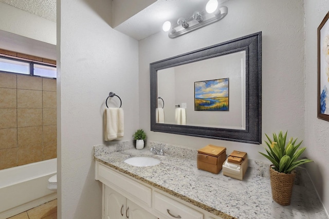 bathroom with tile patterned flooring, vanity, and toilet