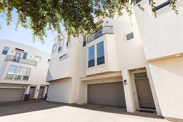 townhome / multi-family property featuring a garage and a balcony