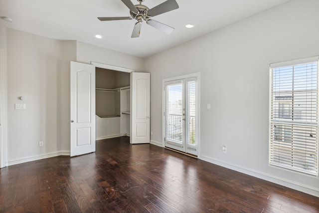 unfurnished bedroom featuring dark hardwood / wood-style floors and ceiling fan