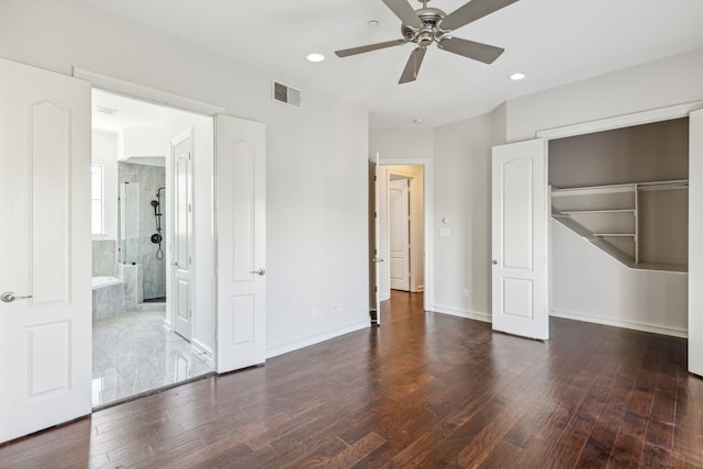 unfurnished bedroom featuring ceiling fan, a closet, dark hardwood / wood-style flooring, and ensuite bath