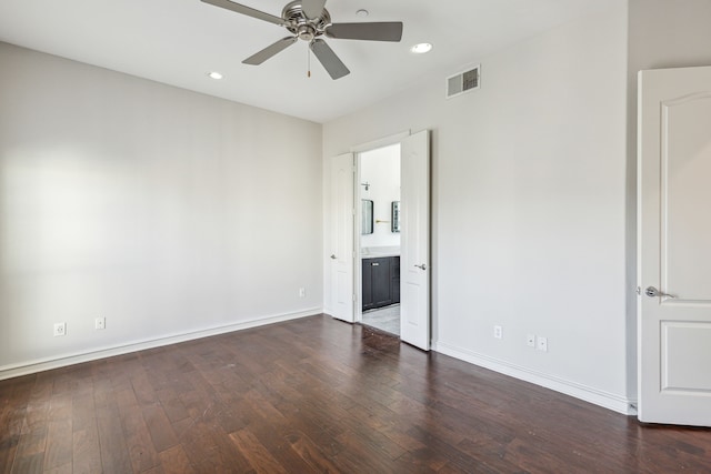 unfurnished bedroom featuring ceiling fan, dark hardwood / wood-style flooring, and connected bathroom