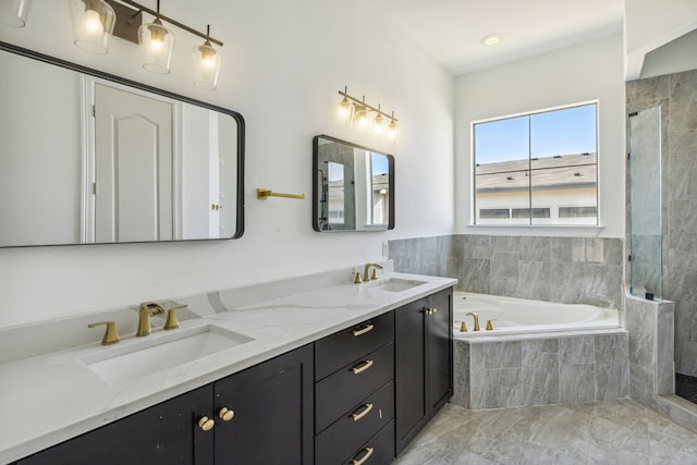 bathroom featuring vanity and independent shower and bath