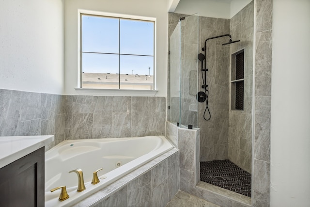 bathroom with vanity and shower with separate bathtub