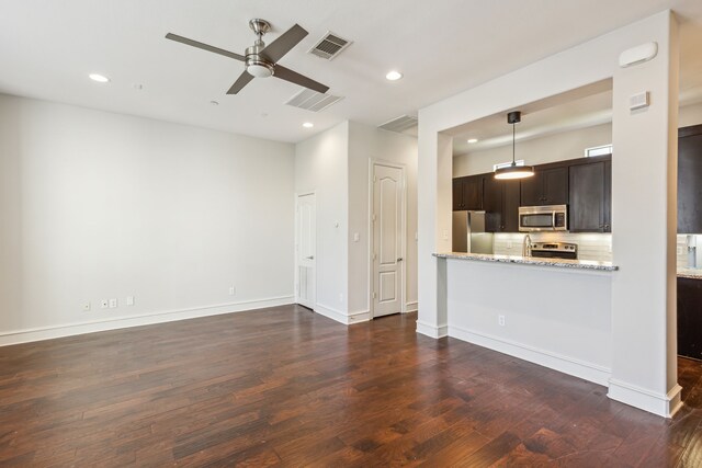 unfurnished living room featuring ceiling fan and dark wood-type flooring